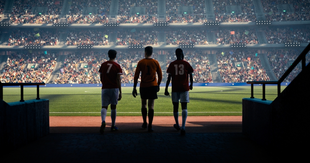 Three,Soccer,Players,Entering,Soccer,Field,On,The,Professional,Stadium.